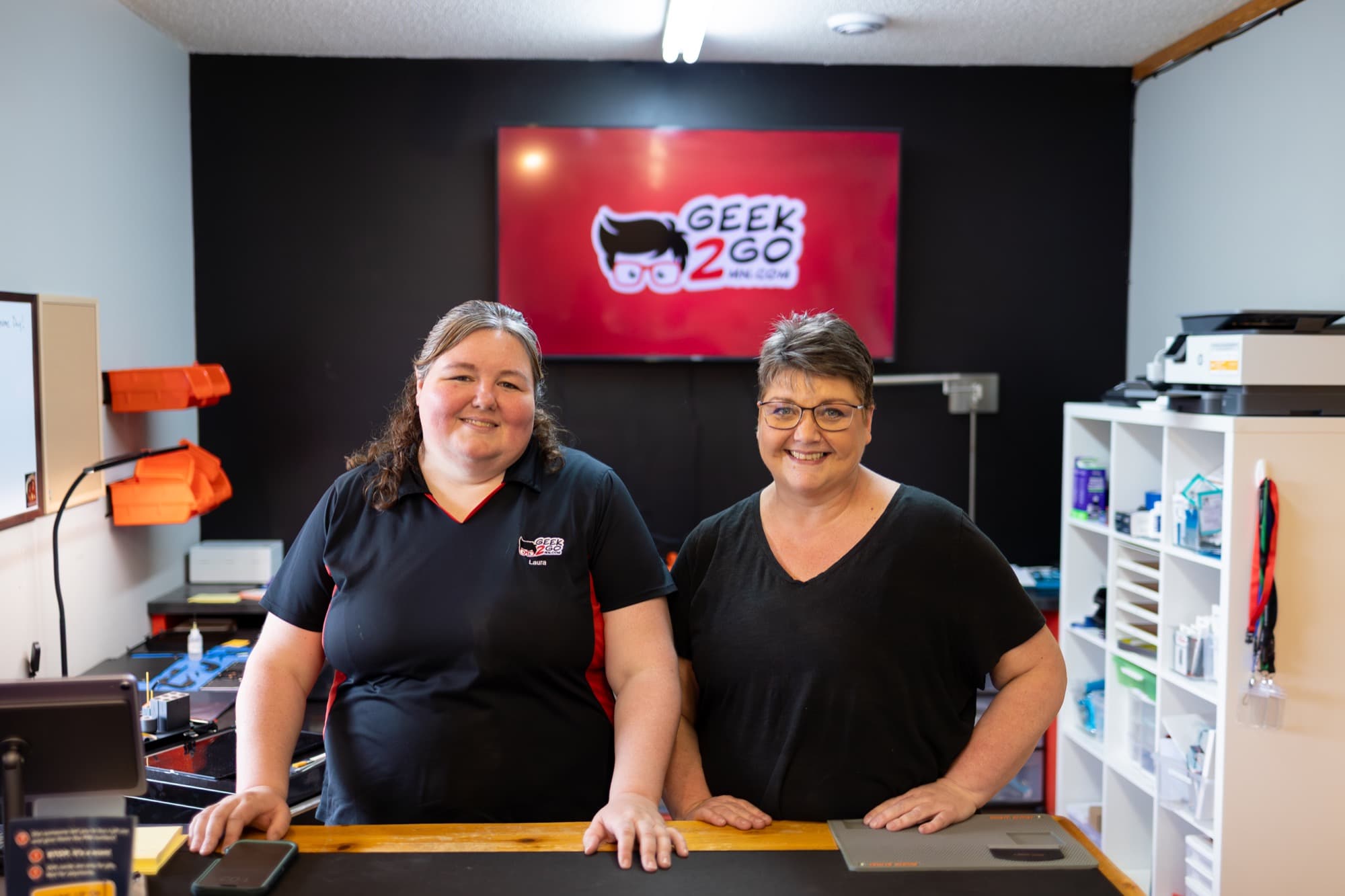 Geek2Go team members behind the service counter
